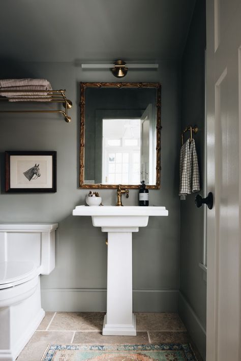 Powder bathroom design idea with dark green wall color, limestone tile flooring, white pedestal sink, brass fixtures and gilded brass mirror. Jean Stoffer Design, Jean Stoffer, Small Downstairs Toilet, Downstairs Toilet, Powder Room Design, Power Room, Pedestal Sink, Downstairs Bathroom, Half Bathroom