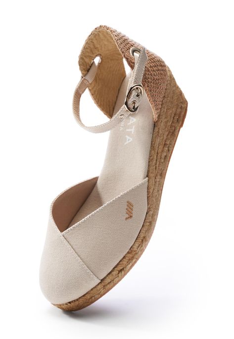 These handcrafted Pubol ankle strap espadrilles from Spain feature a comfortable low wedge, a closed rounded toe, and a 2” all-natural jute heel. They feel like walking on clouds, while their flattering v-vamp is guaranteed to turn heads wherever you go. Superior comfort: Enjoy unbeatable comfort with these easy walking low wedge espadrilles that cradle your feet in softness and provide a subtle lift for all-day ease. Low Wedge: 1.5" natural jute wedge with a 0.5" platform. Ankle Strap: Elegant ankle strap espadrilles with a closed rounded toe, perfect for any occasion. Breathable: Organic cotton canvas keeps your feet fresh on the go. Handmade in Spain: Crafted using traditional artisan techniques passed down for centuries. Low Wedge Espadrilles, Red Espadrilles, Gold Espadrilles, White Espadrilles, Sell Shoes, Closed Toe Sandals, Wedge Espadrilles, High Wedges, On Clouds