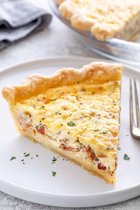 This quiche lorraine recipe has a delicious creamy custard filled with cheese, and salty bits of bacon served in a homemade flaky pie crust. #quiche #quichelorraine Savory Quiche, Quiche Lorraine Recipe, Ham And Cheese Quiche, Homemade Pie Crust, Honey Ham, Baked Pie Crust, Cheese Quiche, Quiche Recipe, Flaky Pie Crust