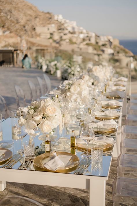 Curating an opulent and elegant affair in Mykonos! ✨ This luxurious wedding featured a grand dinner setup, with mirror-topped tables and an abundance of white blooms. Every detail exuded sophistication, creating a truly memorable celebration.💍 🥂 #luxurywedding #destinationwedding #LuxuryWeddingMykonos⁠ #greece #AegeanElegance#LuxuryByTheSea #ElegantEventDesign #IslandWedding #LoveInGreece #ChicFloralDecor ⁠ Luxury Coastal Wedding, Mykonos Wedding Decor, Rocabella Santorini Wedding, Greece Wedding Theme, All White Beach Wedding, Beach Wedding Design, Beach Theme Wedding Reception, Wedding Turkey, Luxury Beach Wedding