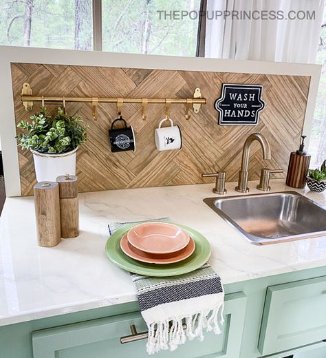 Transform your pop up camper with a simple, yet functional, backsplash. All you need is a few boards and some sash locks to complete the project. Pop Up Trailer Renovation, Boho Pop Up Camper, Pop Up Camper Interior Ideas, Pop Up Camper Storage Ideas, Pop Up Camper Organization, Camper Backsplash, Pop Up Camper Storage, Vintage Camper Renovation, Pop Up Kitchen