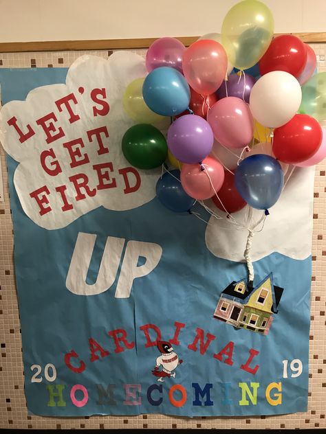 “Let’s Get Fired UP” spirit poster using Disney’s UP as theme - Spirit Week Disney Theme Disney Themed Pep Rally, Homecoming Wall Decorations, Disney School Spirit Week, School Hallway Posters, Senior Homecoming Hallway Themes, Disney Theme Homecoming Floats, Spirit Door Decorations, Homecoming Class Posters, Hoco Door Decorating Football