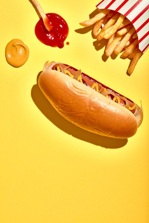 Commercial photography project – Vegan plant based hot dog photography. A classic red and yellow hot dog scene, made with plant based hot dog sausages, shot with graphic, sunny hard light.  I wanted the hot dogs to look stylised and a little pop, but still deliciously edible. I specialise in shooting alt meat and other vegan products that you really want to eat. Nancy Anne – Food, drink and still life photographer • See more of my plant based food photography 🌭 at www.nancy-anne.com Burger Fries Photography, Flash Food Photography, Fun Food Photography, Hot Dog Potato, Hot Dog Photography, Fast Food Photography, Wraps Photography, Burger Illustration, Plant Based Food