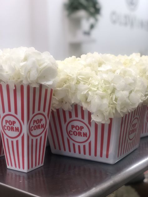 White hydrangea disguised as popcorn for a fun centerpiece idea Popcorn Centerpieces, Popcorn Container Centerpiece, Popcorn Flower Centerpiece, Popcorn Centerpiece Ideas, Popcorn And Cotton Candy Stand, Popcorn Buckets Disney, Disneyland Popcorn Bucket, Hollywood Theme Party Decorations, Dumbo Birthday Party