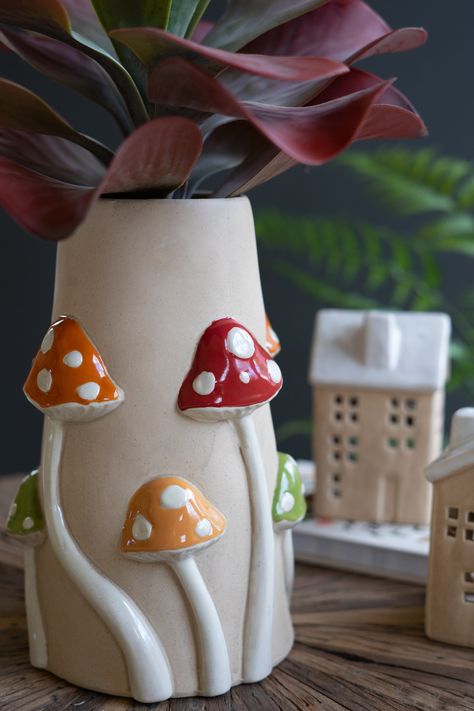 Display your blooms or botanicals in natural style. Toadstools in red, green, and yellow climb this 3D ceramic mushroom vase. Use it for kitchen utensils, year-round arrangements, or corner decor. Imported Brand: Kalalou Mushroom Vase, 3d Ceramic, Ceramic Mushroom, Coil Pottery, Coil Pots, Boho Art Drawings, Corner Decor, Clay Vase, Mushroom Decor