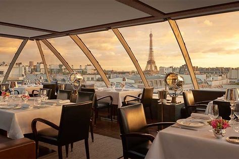 a gorgeous view of the eiffel tower at sunset Eiffel Tower Restaurant, Peninsula Paris, Best Restaurants In Paris, Paris Rooftops, Peninsula Hotel, Restaurants In Paris, Best Rooftop Bars, Restaurant Paris, Luxury Restaurant