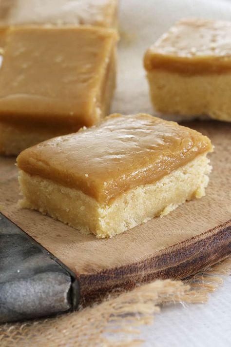 A close up of pieces of slice made with a crunchy base and ginger flavoured icing, placed on a wooden board Ginger Desserts, Ginger Crunch, Slice Recipes, Ginger Biscuits, Ginger Slice, Slices Recipes, Ginger Recipes, Golden Syrup, Icing Sugar