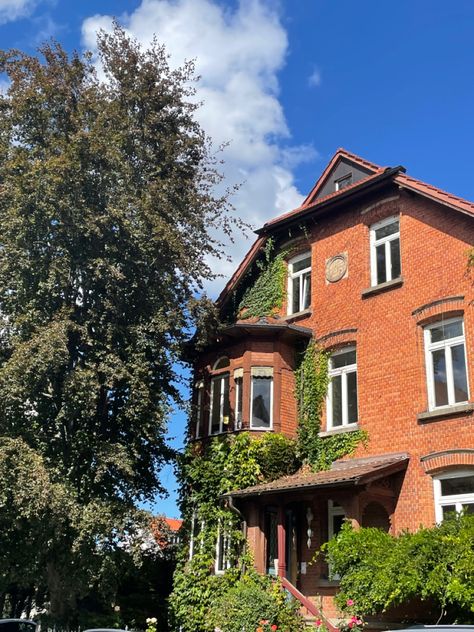 sunny day vibes at this charming old red stone house in southern germany ☀️ / german architecture / historic homes / countryside charm / sunny days / old world beauty / rural life germanredhouse / architecturalcharm / vibrantfacade / homeandgarden / plantlife / cozyresidence / europeanarchitecture / redblockbeauty / germanhomes / urbanflorals German Stone House, Red Stone House, German Core, House In Germany, Houses In Germany, German Architecture, Southern Germany, World Beauty, European House