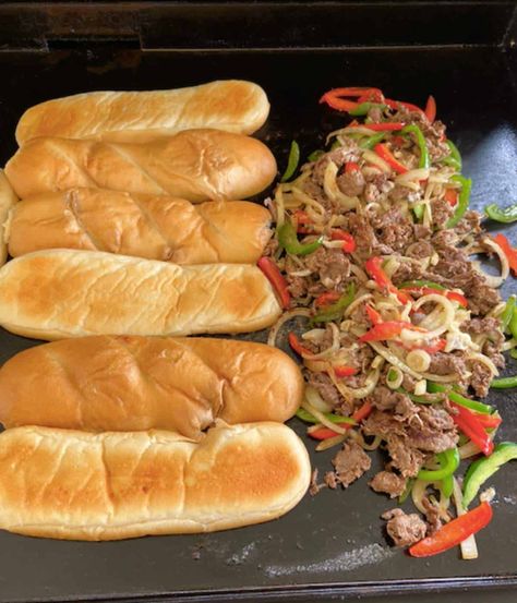 These Blackstone Griddle Philly Cheesesteaks are so easy to make! They're grilled to perfection in minutes and loaded with onions, peppers and cheesy goodness. Best Philly Cheesesteak Recipe, Philly Cheesesteak Recipe, Best Philly Cheesesteak, Philly Cheesesteaks, Philly Cheese Steak Recipe, Cheesesteak Recipe, Sub Rolls, Cheese Buns, Hoagie Rolls