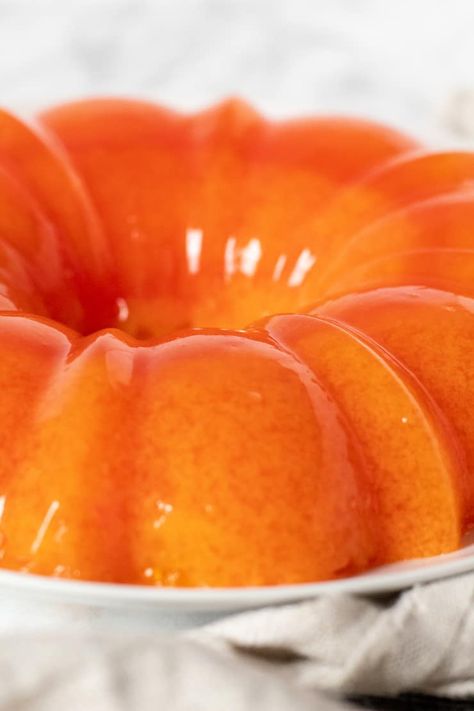 Retro orange sherbet jello salad with orange gelatin, orange sherbet and mandarin oranges, just like mom put on the holiday table every year. #thehungrybluebird #orangesherbetjello #mandarinorangesherbetjello #orangejellosalad #jellowithorangesherbet #sidedish #holidayside #comfortfood Mandarin Orange Jello, Mold Recipes, Orange Jello Salads, Jello Mold Recipes, Congealed Salad, Gelatin Salad, Jello Dessert Recipes, Orange Sherbert, Orange Jello