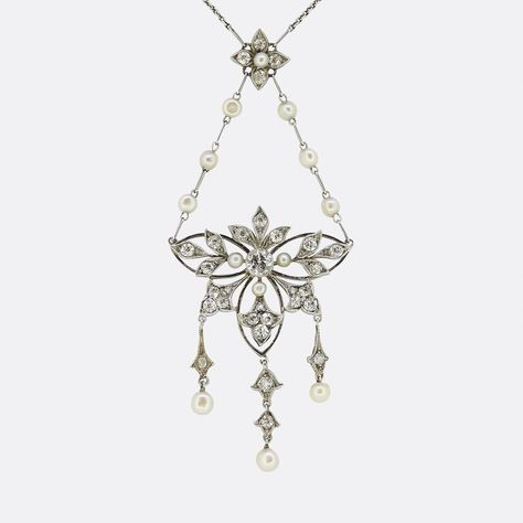 Here we have a delightful lavalier necklace dating back to the Edwardian era. An open platinum frame is centrally set with a round faceted old cut diamond which is surrounded by six fleur-de-lis motifs; each of which is set with matching diamonds and accompanied by freely falling natural pearls below. This focal pendant is suspended from a duo of pearl set chains which emanate from a diamond and pearl flower cluster above. This beautiful ensemble collectively hangs from a matching antique platin Shifting Wardrobe, Lavalier Necklace, The Edwardian Era, Bolt Ring, Belcher Chain, Flower Cluster, Antique Necklace, Edwardian Era, Necklace Box