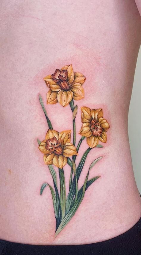 Hummingbird And Daffodil Tattoo, Yellow Daffodils Tattoo, Tulip And Daffodil Tattoo, Daffodil And Jonquil Tattoo, Butterfly Daffodil Tattoo, Color Daffodil Tattoo, Daffodil Tattoo Color, Daffodil With Bee Tattoo, Daffodil With Butterfly Tattoo