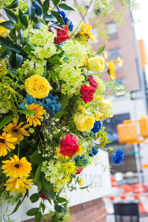 Beautiful spray of yellow and red roses, golden daisies, royal blue bachelor's buttons and light green filler flowers and greens Filler Flowers, Bachelor Buttons, Floral Installations, Meatpacking District, Flower Bouquets, Flower Market, Red Flowers, Flowers Bouquet, Perfect Place