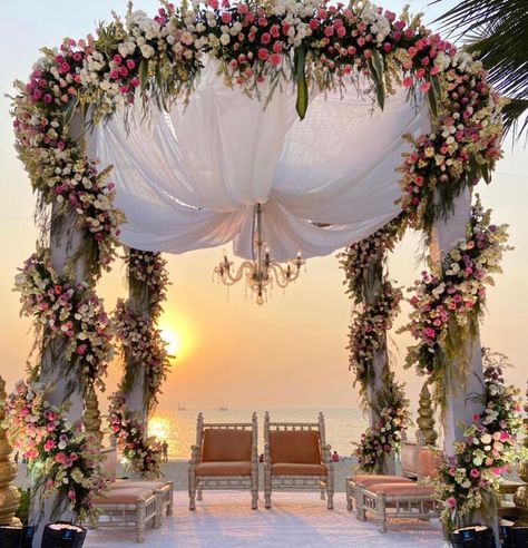 Ever thought of a sunset wedding? With the cloud-speckled sky, sunset colors with orange and yellow sprinkles you can create a breathtaking view on your D-day. If you love bright colors then prepare yourself for the best sun-inspiring wedding decor which is spectacular and gorgeous. Here is the list of top sunset weddings and remarkable decor. We will first start with beautiful Mandap decors that are ravishing and mind blowing here are some best decor ideas: 1. Pastel Hues with Lush Flowers 2. S Sunset Wedding Mandap, Sunset Mandap Decor, Pastel Sunset Wedding, Sunset Indian Wedding, Day Wedding Decoration Indian, Saptapadi Decoration Ideas, Sunset Wedding Decor, Wedding Mala Rose, Mandap Setup