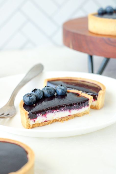 These mini blueberry tarts are made with a lemon zested pastry shell, lemon cream cheese mousse, and fresh blueberry coulis. You'll love each bite of these homemade tarts. Get the recipe from Bakes & Blunders. #blueberry #pastry Homemade Tarts, Blueberry Pastry, Blueberry Coulis, Blueberry Tarts, Cream Cheese Mousse, Delicious Lemon Desserts, Mini Lemon Tarts, Mini Tart Recipes, Cheese Mousse