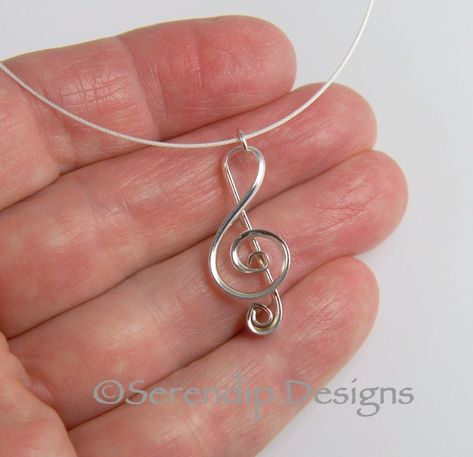 This Argentium Sterling Silver treble clef pendant is handmade out of domed, tarnish-resistant wire.  I hand fabricated this shiny treble clef bringing it to a high polish for you or your favorite music lover to enjoy.   This unique silver pendant comes on a cable that is made of 49 very tiny steel cables that are bound together and coated with nylon embedded with Sterling Silver flake to give it a glowing silver appearance that will not fade or tarnish.   I make these individually and entirely Copper Wire Crafts, Jewelry Magic, Music Note Necklace, Music Necklace, Diy Earrings Easy, Band Jokes, Wire Wrapped Jewelry Tutorials, Aluminum Jewelry, Celebrity Faces