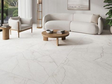 The Class Porcelain Tile Collection, offers a touch of elegance to any space. Available in large format 24″ x 48″ and 48″ x 48″ options. Available in two warm colors, Bianco and Avorio. Inspired by the purity and beauty of Avorio di Segesta marble, these tiles feature fine and delicate veining in earth tones that contrast with the creamy background, creating a captivating visual effect. The Class Porcelain Tile Collection is a versatile and powerful choice for enhancing the beauty of any room. Marble Flooring Design Living Room, Nordic Living Room Inspiration, Creamy Background, Marble Flooring Design, White Marble Tiles, Living Room Tiles, Nordic Living Room, Marble Flooring, Marble Floor