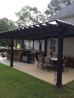 I like this open layout. Like the pergola over the table, grill, and bar. Don't like the plastic on top and wouldn't do ceiling fans or lanterns. White Christmas lights would be prettier Small Covered Patio, Table Grill, Design Per Patio, Concrete Patios, Pergola Design, Budget Patio, Backyard Pergola, Backyard Porch, Custom Decks