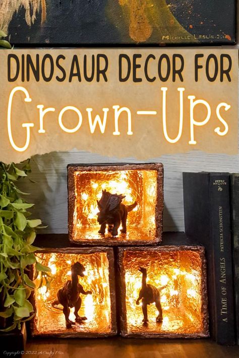 Did your son or daughter collect prehistoric creatures when they were younger? We had a whole drawer full, so when my son moved into his own apartment, I decided to repurpose those plastic toys into fun dinosaur décor for grown-ups. This tutorial will show you how it’s done. #ACraftyMix Diy Dinosaur Classroom Decor, Dinosaur Crafts For Adults, Dinosaur Room Ideas Diy, Diy Dinosaur Toy, Plastic Dinosaur Crafts, Diy Dinosaur Decor Bedroom, Dinosaur House Decor, Dinosaur Living Room, Diy Dinosaur Gifts