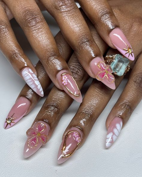 when the set has all the elements 💖 #pinknails #prettynails #vacationnails #cruisenails #summernails #floralnails #femininenails #justagirl #3dflower #3dnailart #goldchrome #chromenails #almondnails #mediumnails #stilettonails #blacknailtech #frenchnails #frenchtipnails #longnails #nailart #nailartist #handpaintednailart #tampanails #tampanailtech #813nails #813nailtech #clearwaternails #stpetenails #newportricheynails #vbeautypure Cute Almond Nails With Charms, Princess Nails Almond, Cute Almond Shape Nails, Almond Junk Nails, Blush Nail Designs, Fairytale Nails, Abstract Nail Designs, Ethereal Nails, Whimsical Nails