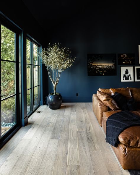 Dark Blue Paint Colors For Living Room, Deep Blue Walls Living Room, Dark Navy Living Room Accent Wall, Mens Living Room Ideas Apartments Masculine Interior, Deep Blue Home Decor, Blue Colors For Living Room Walls, Dark Blue Lounge Room, Masculine Blue Living Room, Moody Dark Blue Living Room