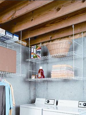 Rafter-hung shelves create storage where none would otherwise be possible.  - WomansDay.com Unfinished Basement Laundry, Basement Laundry Room Makeover, Perfect Laundry Room, Create Storage, Basement Organization, Room Storage Diy, Basement Laundry Room, Basement Laundry, Basement Storage