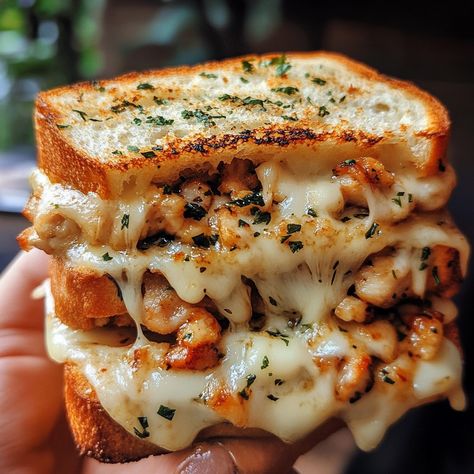 Cheesy Chicken Garlic Bread Sandwich 🥪🧄 Ingredients: 2 large pieces of garlic bread (store-bought or homemade) 1 cup cooked chicken, shredded 1/2 cup mozzarella cheese, shredded 1/4 cup Parmesan cheese, grated 1/4 cup cream cheese, softened 1 tsp garlic powder 1 tsp Italian seasoning Salt and pepper to taste Fresh parsley, chopped (for garnish) Instructions: Prepare the Filling: In a bowl, combine the shredded chicken, mozzarella cheese, Parmesan cheese, cream cheese, garlic powder, Italian s... Garlic Bread Chicken Sandwich, Bread Chicken Sandwich, Garlic Bread Sandwich, Garlic Bread Chicken, Chicken Garlic Bread, Bread Store, Bread Chicken, Chicken Mozzarella, Chicken Shredded