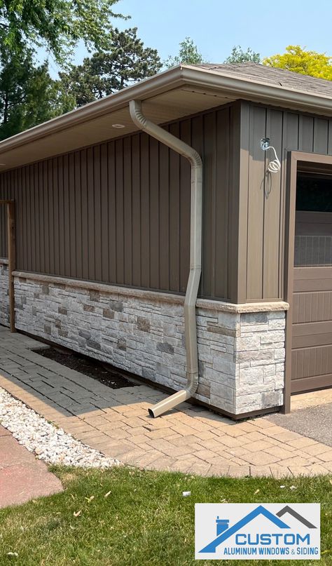 House with vinyl Board & Batten siding in Rockport Brown and Versetta Stone in Mission Point Colour Homes With Vertical Siding, Stone With Board And Batten Exterior, Vynil Siding House Exterior With Stone, Siding Alternatives Exterior, Replacing Siding On House, Outdoor Siding Ideas, Versetta Stone Exterior, Gentek Siding, Board And Batten Siding Colors