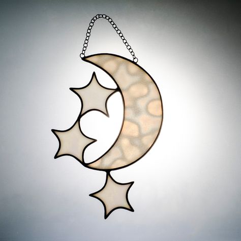 This elegant sun-catcher features a crescent moon surrounded by stars, a beautiful addition to your holiday home decoration. This half-moon suncatcher can be placed as a decorative piece on a wall or window (it is delivered to you with a window attachment). It can also be hung outdoors and is a perfect Mothers day gift and Christmas gift for loved ones. Moon Suncatcher, Hanging Stars, Glass Garden Art, Stained Glass Suncatchers, Moon Decor, Glass Garden, Star Ornament, Moon And Stars, Window Hanging