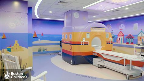 The MRI room at Boston Children's Weymouth. The walls are painted with a beach and sailboats, the MRI is painted to look like a ferry, and there is an adairondack chair in the bottom left corner. Welcome To Boston, Boston Childrens Hospital, New Space, South Shore, Getting To Know, Pediatrics, Over 40, The South, Boston