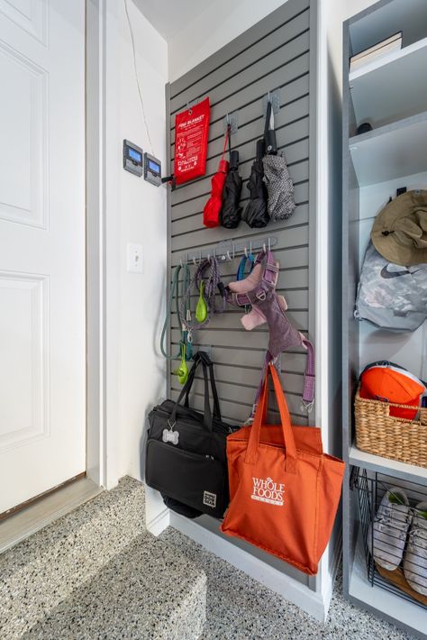 "Wow" is the only way to describe this incredible garage remodel in Burke! Our clients added epoxy flooring in our decorative River Rock color coating, pewter frost cabinetry throughout, multiple garage organizers, and much more to use every possible inch to make the space as functional as possible. Now this family has a place for literally everyone and everything. #Garageflooring #garageorganization #customgaragecabinetry #garagestorage #epoxyflooring Amazing Garage Interiors, Husky Garage Organization, Two Car Garage Organization, Ball Storage Garage, Garage Goals, Garage Laundry Rooms, Overhead Storage Rack, Garage Mudroom, Garage Storage Inspiration