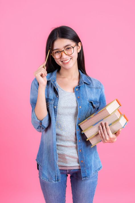 Portrait pretty teenage female holding books in her arm and using pencil on pink, education concept | Free Photo #Freepik #photo #freebook #freeeducation #freewoman #freegirl Woman Holding Book, Girl With Book, Education Photo, Student Images, Online Degree Programs, Student Photo, Importance Of Education, Photoshop Design Ideas, Mode Tips