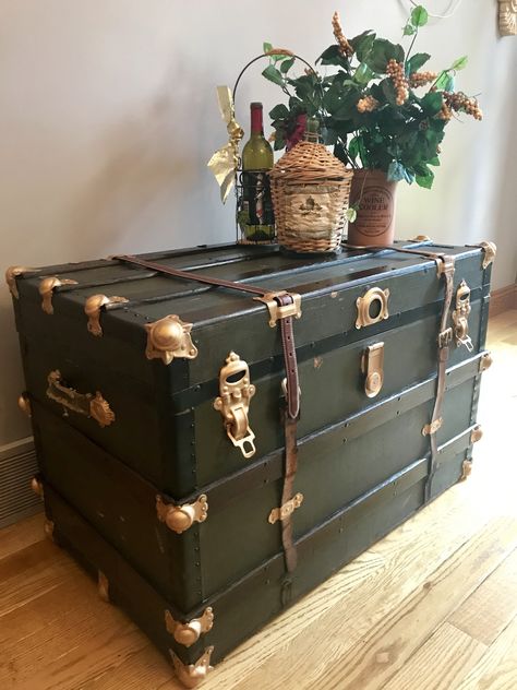 Refinishing this classic old steamer trunk took a lot of work. After stripping the old paper lining the interior, we stained and polyurethaned the wood to a beautiful finish. The green canvas exterior was in good shape. But the straps needed to be replaced with old belts. The exterior wood was stained and the exterior brass accents were painted with Gold Leaf Rub n’ Buff. Refurbish Old Trunk, Refinished Steamer Trunk, Restored Steamer Trunk, Refinish Old Trunk, Painted Steamer Trunk, Steamer Trunk Ideas Repurposed, Old Trunks Makeover, Old Trunk Ideas Decor, Old Trunk Ideas Repurposed