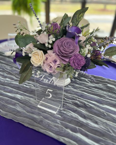 These low compote arrangements may be my favorite centerpieces ever! Are you as obsessed as me with these purple wood flower designs? These are perfect centerpieces for any event from a wedding to a brunch. If you are someone who runs, multiple events per year for your organization or offer complimentary decor at your venue, these would be a perfect reusable investment. #ctflorist #ctevents #solawoodflowers #connecticutwedding Purple Retirement Party Ideas, Purple Flower Arrangements Centerpieces, Purple Wedding Flowers Centerpieces, Purple Flower Centerpieces, Purple Flower Arrangements, Purple Wedding Centerpieces, Purple Centerpieces, Rehearsal Dinner Decorations, 50s Party