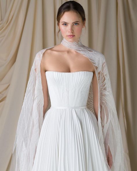 Paolo Sebastian on Instagram: “The Wild Swans • PSSS2209 – Sunray pleated gown with embroidered cape featuring silk organza feather cutwork detailing. Image by…” The Wild Swans, Gown With Cape, Wild Swans, Embroidered Cape, Paolo Sebastian, Swan Dress, Cape Wedding Dress, Pleated Gown, Chic Brides