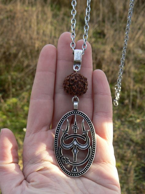 This is a piece of powerful protection jewelry for men. The necklace on a silver plated chain and made of genuine Rudraksha mala seed and Trishul pendant, which is the symbol of Hindu Lord Shiva. Perfect and symbolic gift for Yogi. Trishul (or Trishula) means three-headed spear i.e. Rudraksha Pendant Gold For Men, Rudraksha Jewelry For Men Silver, Trishul Pendant, Rudraksha Mala Silver For Men, Rudraksha Pendent For Men, Lord Shiva Gold Pendent, Shiva Trishul, Hindu Symbol, Rudraksha Jewelry