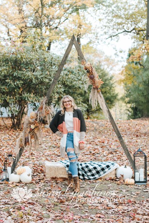 senior photo inspo, fall mini sessions, autumn aesthetic, triangle arch, triangle arch for weddings, triangle arch for photo booth Arch For Photoshoot, Triangle Arch Photoshoot, Fall Triangle Arch, Fall Photoshoot Backgrounds, Triangle Arch Fall Photoshoot, Fall Photoshoot Props Mini Sessions, Fall Photo Backdrop Ideas Outdoor, Fall Photoshoot Background Ideas, Fall Photo Setup