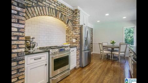 Love this timeless brick range hood created over the stove Brick Backsplash Kitchen White, Kitchen White Cabinets Black Island, Brick Backsplash Kitchen White Cabinets, Brick Range Hood, White Cabinets Black Island, Brick Stove, Beam In Kitchen, Arch Bar, Backsplash Kitchen White Cabinets