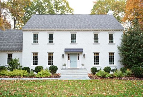 What We've Changed Since Painting Our Brick House White | Young House Love White Colonial House, White Colonial, Colonial House Exteriors, Metal Awning, Painted Brick House, Colonial Exterior, Young House, Young House Love, Outdoor Stone