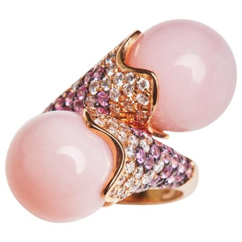 This Rose Gold cocktail ring is adorned with White Diamonds and Pink Sapphires and highlights two graceful spherical Rose colored Opal stones. Fine craftsmanship and elegant details are the highlights of this conversation piece. 54 Diamonds 0.98 Carats 58 Pink Sapphire 1,37 Carat 2 Rose Opals 26.22 Carats Size EU 56 US 7,75 Founded in 1974, Gianni Lazzaro is a family-owned jewelery company based out of Düsseldorf, Germany. Although rooted in Germany, Gianni Lazzaro's style and design is more rem Rose Gold Cocktail, Pink Sapphire Diamond Ring, Color Stones Jewelry, Diamond Bracelet Design, Vintage Cocktail Ring, Fancy Jewellery Designs, Stones Jewelry, Gold Cocktail Ring, Color Stones