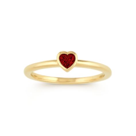 A single vibrant heart-shaped natural ruby  at approximately .18 carat total gem weight  is the focal point in this lovely stackable ring. Crafted of quality 14 karat yellow gold  the bezel-set design measures 4.8mm wide and is part of our Limited Collection. Heart Shaped Ruby Ring, Favorite Engagement Rings, Ring Heart, Ring Bezel, Bezel Ring, Platinum Jewelry, Heart Shaped Diamond, Set Ring, Filigree Design