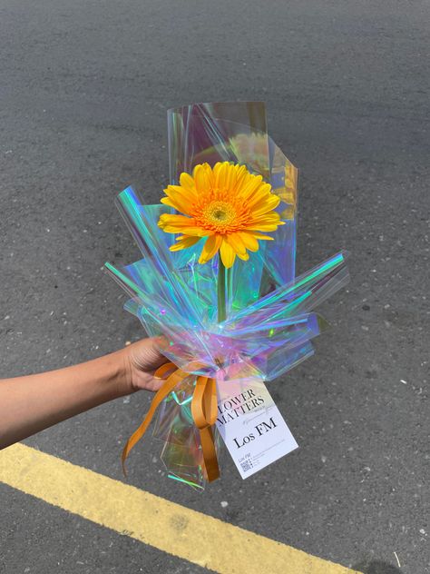 Single holographic wrap bouquet Los FM florist jogja / Toko bunga jogja / jual bunga jogja Single Gerbera Bouquet, Holographic Flower Bouquet, Holographic Bouquet, Bouquet Wrap Ideas, Bucket Flowers, Wrap Bouquet, Wrapping Bouquets, Single Bouquet, Artificial Flower Bouquets