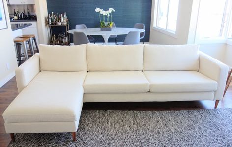 Next, I substituted the basic Ikea cover for a custom cover from Bemz, a Swedish company that specializes in high-end Ikea slipcovers. I chose the Porridge Linara by Romo, and got the Karlstad three seater sofa cover ($439, originally $549) and chaise add on cover ($223, originally $279). Choosing a slipcover for an Ikea piece comes with many practical benefits. For one, they're machine washable — so I could feel good about that light color. Bemz also produces their custom covers on demand, whic Ikea Sectional, Karlstad Sofa, Ikea Couch Covers, Ikea Karlstad, Ikea Couch, Designer Sofa, Ikea Sofa, Three Seater Sofa, Living Room Makeover