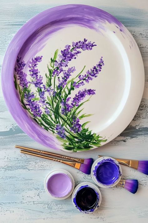 A pottery painting featuring purple lavender flowers on a circular plate with paintbrushes and purple paint jars. Detailed Pottery Painting, Lavender Pottery, Pottery Painting Ideas Easy, Pottery Painting Ideas, Plain Mugs, Painting Ideas Easy, Painted Coffee Mugs, Painted Clay Pots, Painted Clay