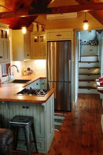 Inside the 352-square-foot farmhouse is a bedroom above the gooseneck with stand up headroom, a real closet, and a built-in queen size bed. Tiny House Kitchen Storage, Timbercraft Tiny Homes, Motorhome Camping, Lake Retreat, Tiny House Storage, Tiny House Interior Design, Rv Kitchen, Best Tiny House, Farmhouse Kitchen Cabinets