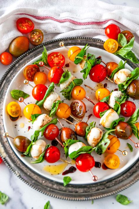 A quick and easy vegetarian appetizer perfect for any get together, these delicious Caprese Salad Bites are sure to impress. With only four basic ingredients, you can make a batch in 15 minutes flat! From aberdeenskitchen.com #caprese #salad #bites #skewers #appetizer #snack #fingerfood #Italian #gameday #vegetarian #glutenfree Gameday Brunch, Caprese Salad Bites, Vegetarian Appetizers Easy, Salad Bites, Caprese Salad Skewers, Vegetarian Appetizer, Party Bites, Basil Leaf, Tomato Mozzarella