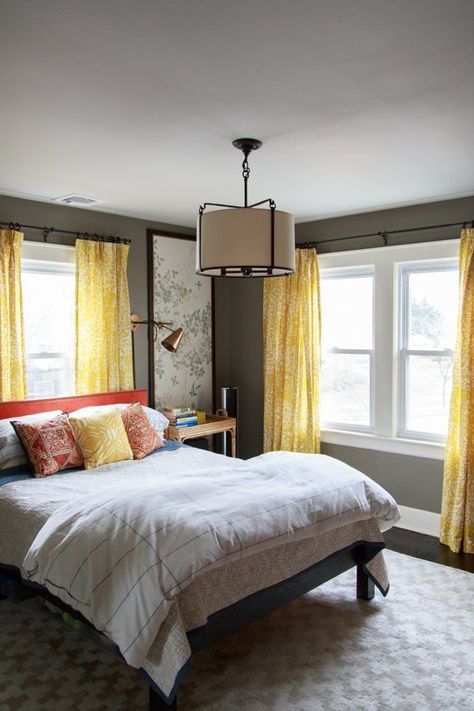 A tiny bedroom might mean you have to live without some storage space, but by no means does it mean you have to live without style and beauty.  See below for the proof! via My Domaine Go for impact!  With an iron canopy bed as dramatic as this one, no one is going to notice … Bed Under Windows, Yellow Curtains, Yellow Bedroom, Trendy Bedroom, Gray Bedroom, Simple Bedroom, Remodel Bedroom, Cool Stuff, Minimalist Bedroom