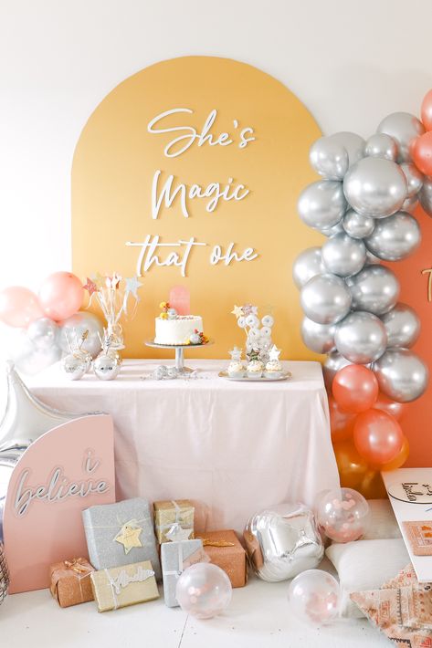 This fun, sparkly birthday party is perfect for your little one's special day! Custom lettering helps define the party and add texture and color to the backdrop. All party supplies including the backdrop lettering, cake topper, cupcake toppers, donut kabobs, printable personalized wands, swizzle sticks and more can be purchased together to easily create the perfect magical party! Shes Magic That One First Birthday, She’s Magic That One Birthday, One Magical Year Birthday, Backdrop Lettering, Donut Kabobs, Sparkly Birthday Party, Lettering Cake, Sparkly Birthday, Magical Party