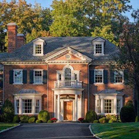 This new 7,000 square foot brick home was built for a growing young family as a long-term family homestead. The Georgian revival style was chosen to help the house fit seamlessly into the neighborhood, a region already marked by its early 20th century Georgian and Tudor Revival homes. #redbrickhouse #slateroof #modillions #dormers #palladianwindow #doriccolumns #windowbay #frontportico #curvedporch #georgianstyle #traditionalarchitecture #classicaldesign #khakumwood #GreenwichCT Georgian Revival Homes, Georgian Style Homes, Dream Things, Georgian Architecture, Brick Exterior House, Georgian Homes, Colonial House, Sims House, Dream House Exterior