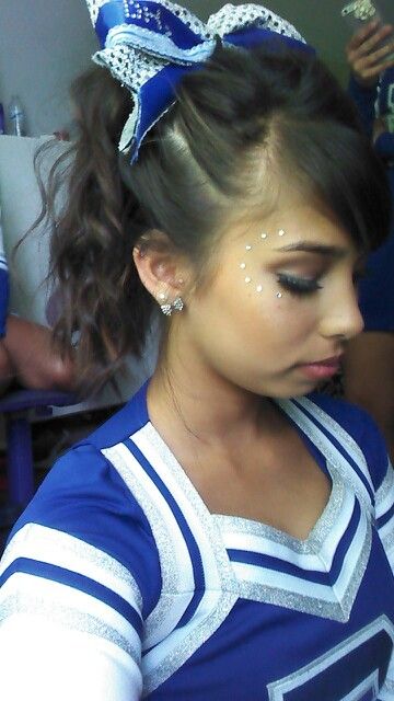 Cheer hair and makeup. Sparkles, bows, and bronzer! Cheer Pictures Makeup, Cheer Dance Makeup, Glitter Cheer Makeup, Blue And Gold Cheer Makeup, Gameday Makeup Cheer, Game Day Cheer Makeup, Cheer Leader Makeup, Cheer Makeup High School Glitter, Cheerleading Makeup Ideas